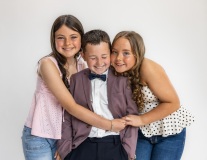 Grace and Holly give Charlie a squeeze just to make him laugh - He's had enough of photos, posing and them!