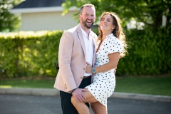 Relaxed outdoor portrait capturing a playful, sneaky moment between Louise and Alan in bright sunshine before the First Communion celebrations.