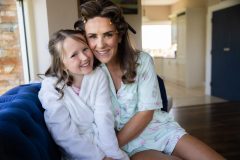 Relaxed documentary style portrait of Willow and her mum during the excitement of the morning preparations for her First Communion.