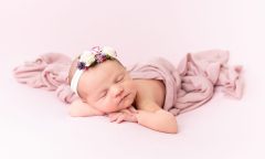 photo of Newborn baby girl, Nora, sleeping peacefully during a professional newborn photography session in Ireland. For a newborn photography FAQ page