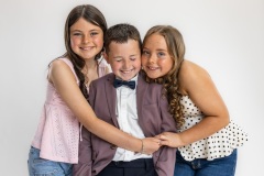 Grace and Holly give Charlie a squeeze just to make him laugh - He's had enough of photos, posing and them!
