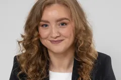 Natural professional headshot of Amy with a friendly expression, taken in a studio near Dublin