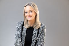 Sarah's professional headshot in a studio setting with soft lighting.