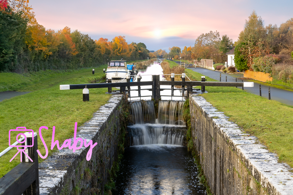 Photo of a Boat moored at the 15th lock near Chambers Bridge on the Royal Canal, Kilcock, Co Kildare, with clear waters and verdant banks