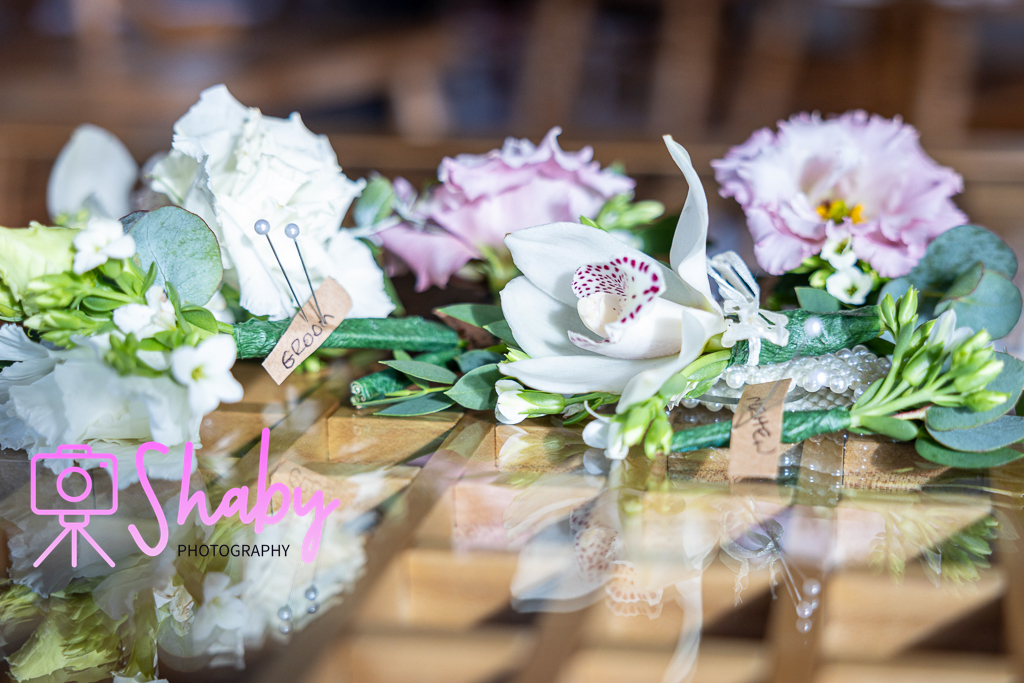 Elegant array of wedding flowers arranged for family members, showcasing vibrant colors and intricate designs, meticulously prepared by Shaby Photography for a memorable wedding day.