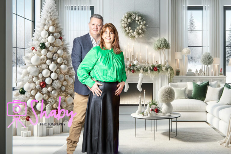 Fun and festive Christmas family portrait by Shaby Photography, capturing a smiling family in holiday attire, enjoying a playful and joyful photography session with a seasonal backdrop