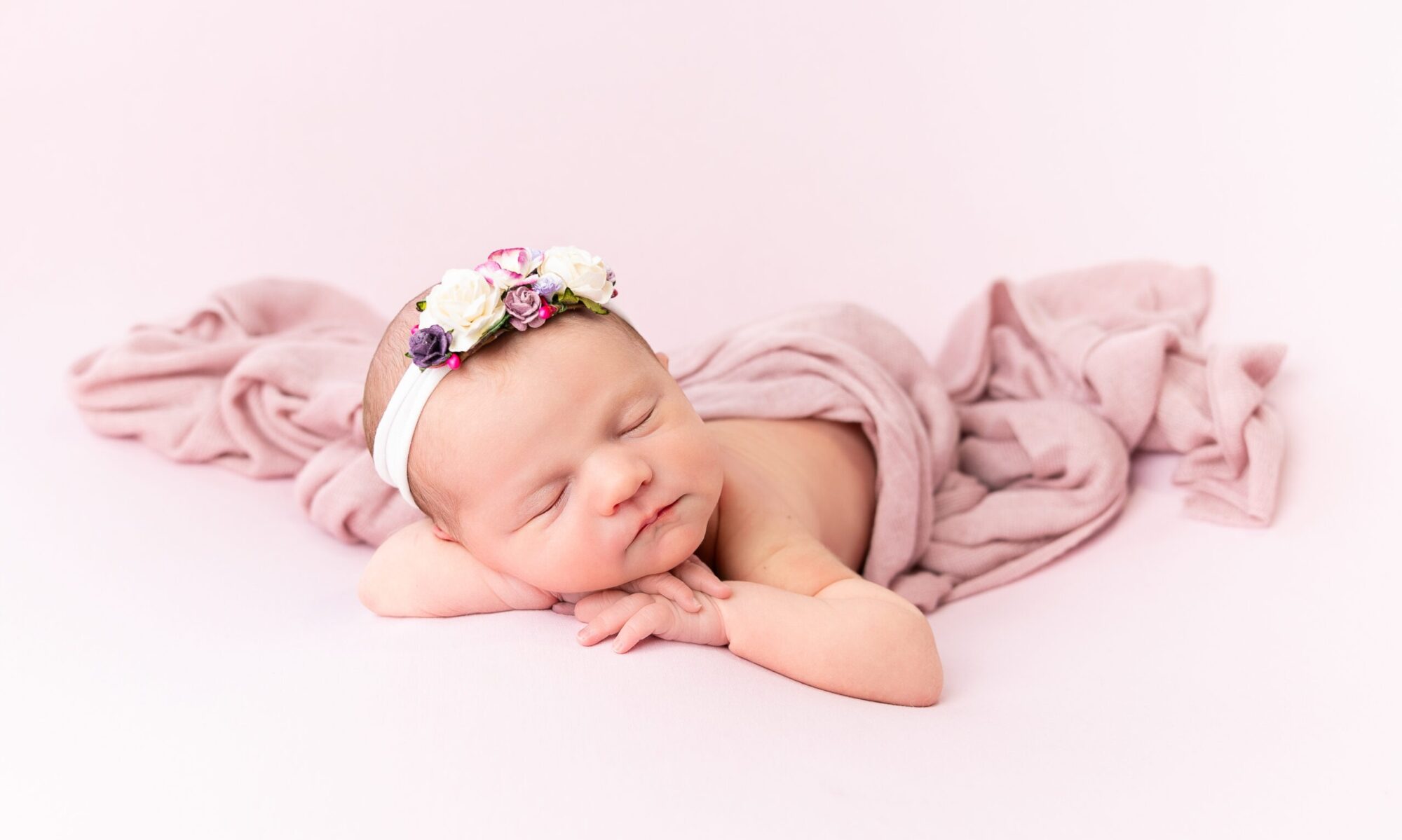 photo of Newborn baby girl, Nora, sleeping peacefully during a professional newborn photography session in Ireland. For a newborn photography FAQ page