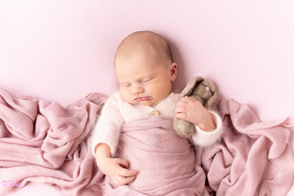 newborn photography session - Newborn baby girl Nora sleeping peacefully with a gentle smile, during a professional photography session in Ireland. Newborn and children photographer in Meath