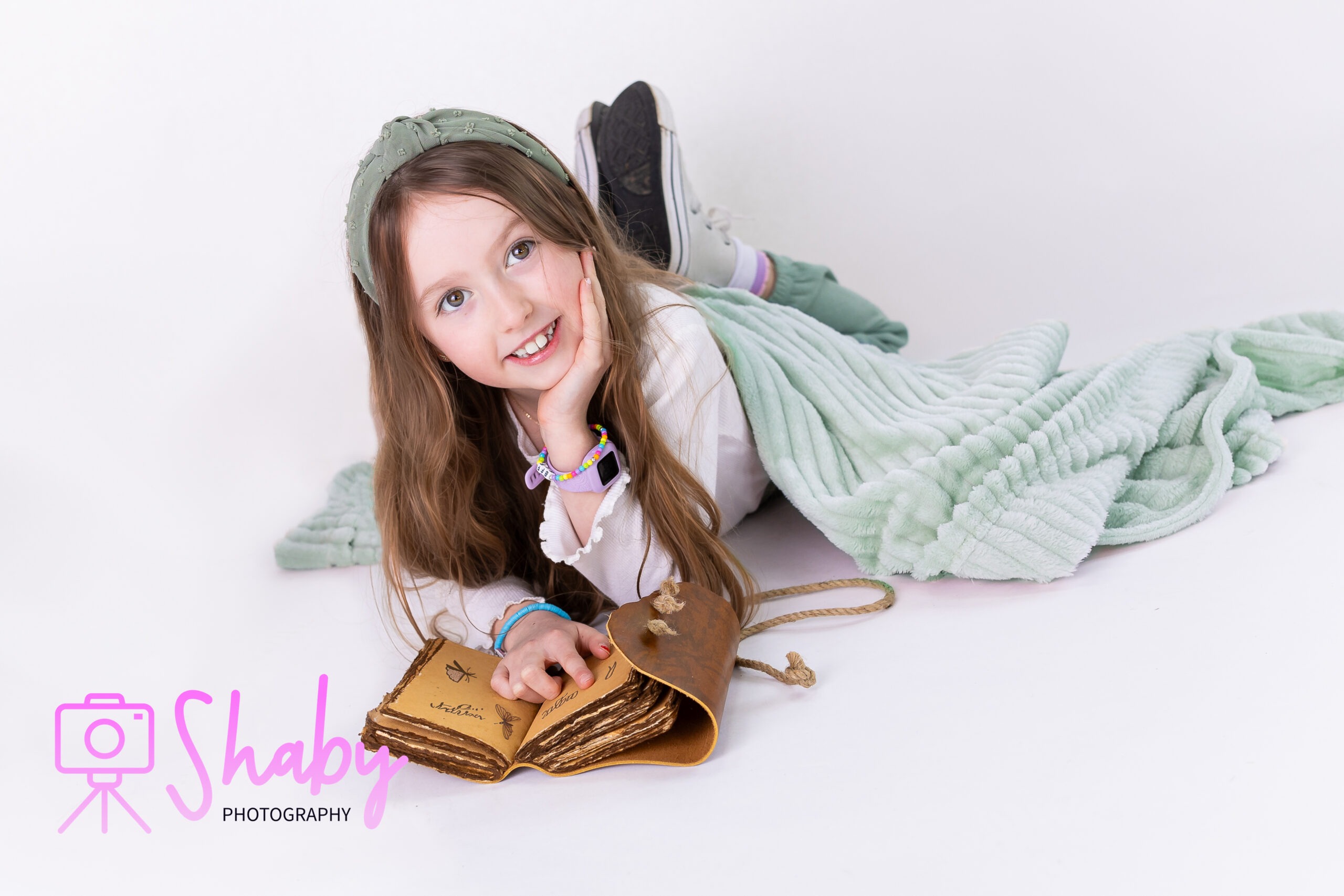Unplanned yet perfectly captured studio portrait of sisters Hayley and Willow, sharing a moment of laughter and closeness. Their spontaneous visit shines through in this stunning photo that highlights their natural beauty, happiness, and deep bond. Taken by Shaby.ie a newborn and childrens photographer based in Meath