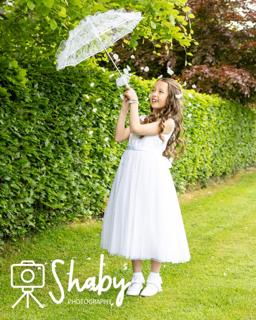 First Communion Photography showing Hailey on her lawn before her first communion. Family photoshoot, exclusive photography by Sharon Byrne at www.Shaby.ie