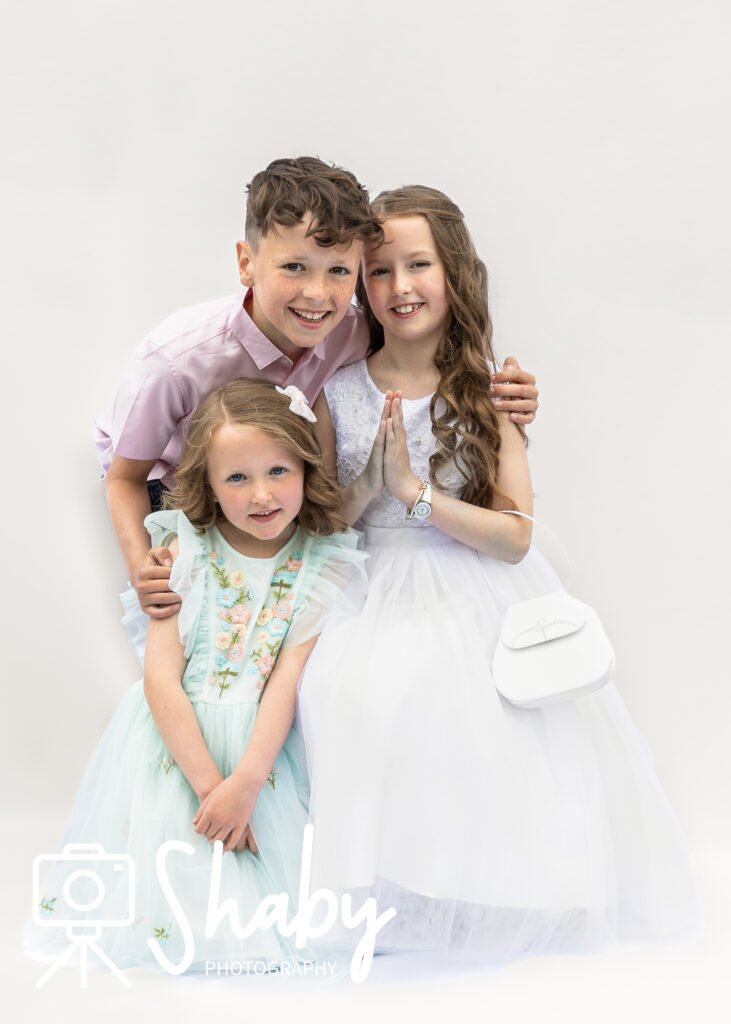 First Communion Photography showing Hailey with her family before the church. Family photoshoot, exclusive photography by Sharon Byrne at www.Shaby.ie