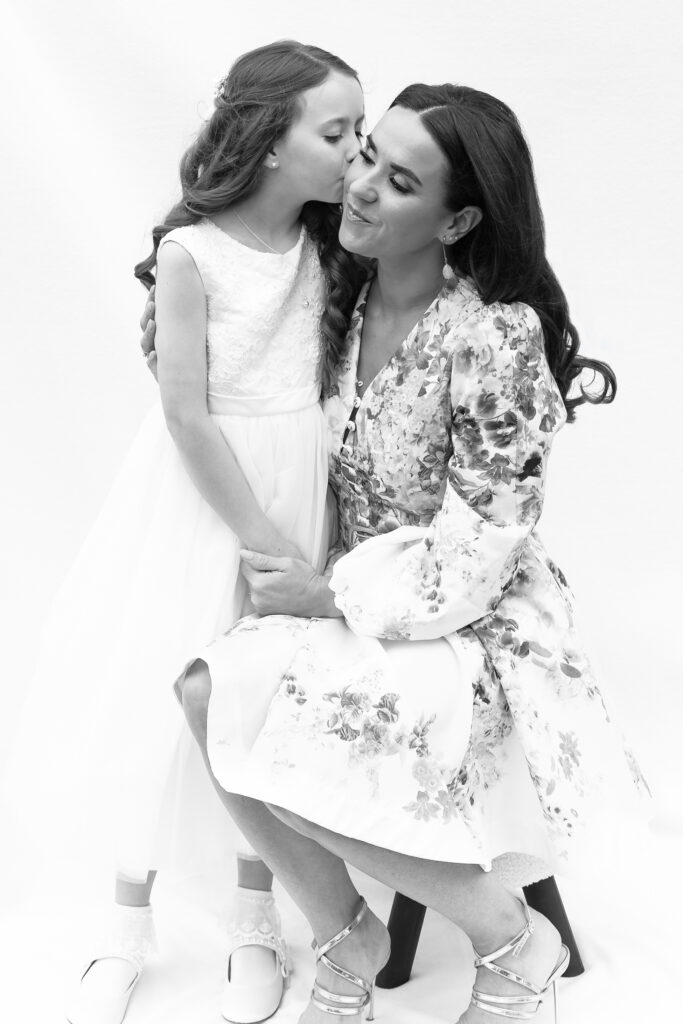 First communion photography showing a very special moment between Hailey and her mother taken by shaby photography at www.shaby.ie