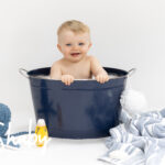 Photo from baby photography session or photoshoot of a beautiful baby boy, posing in a bath, by www.shaby.ie