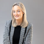 Sarah's professional headshot in a studio setting with soft lighting.