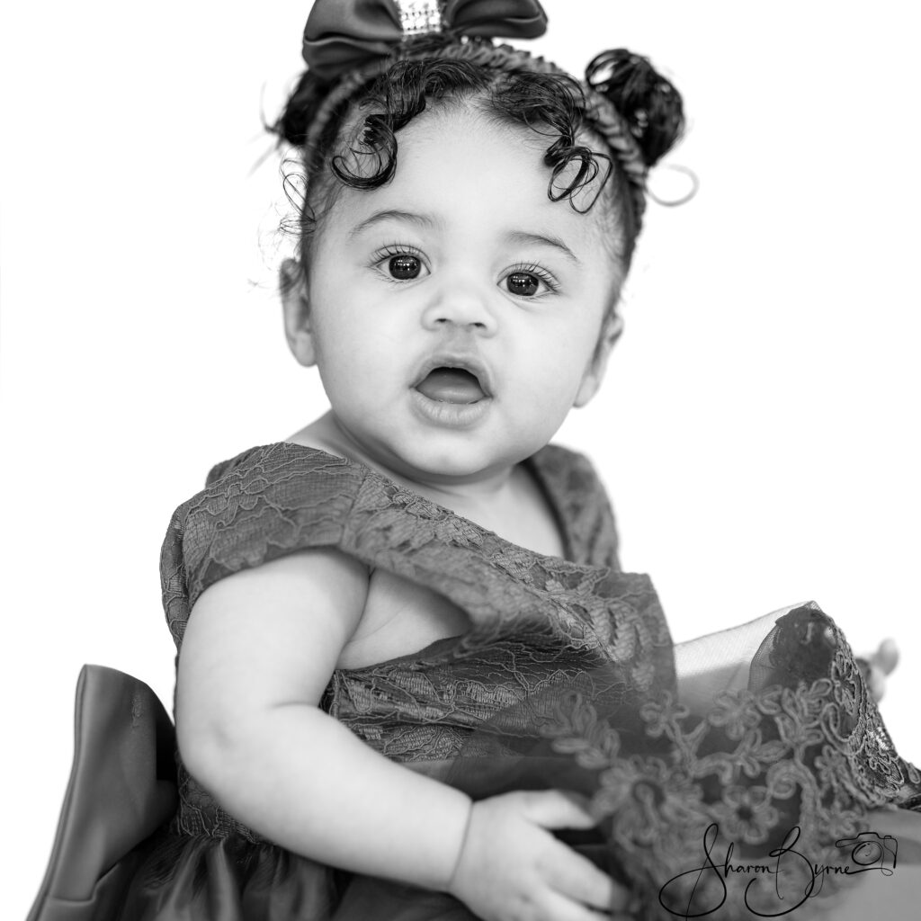 Smiling 10-month-old baby during a toddler photoshoot.