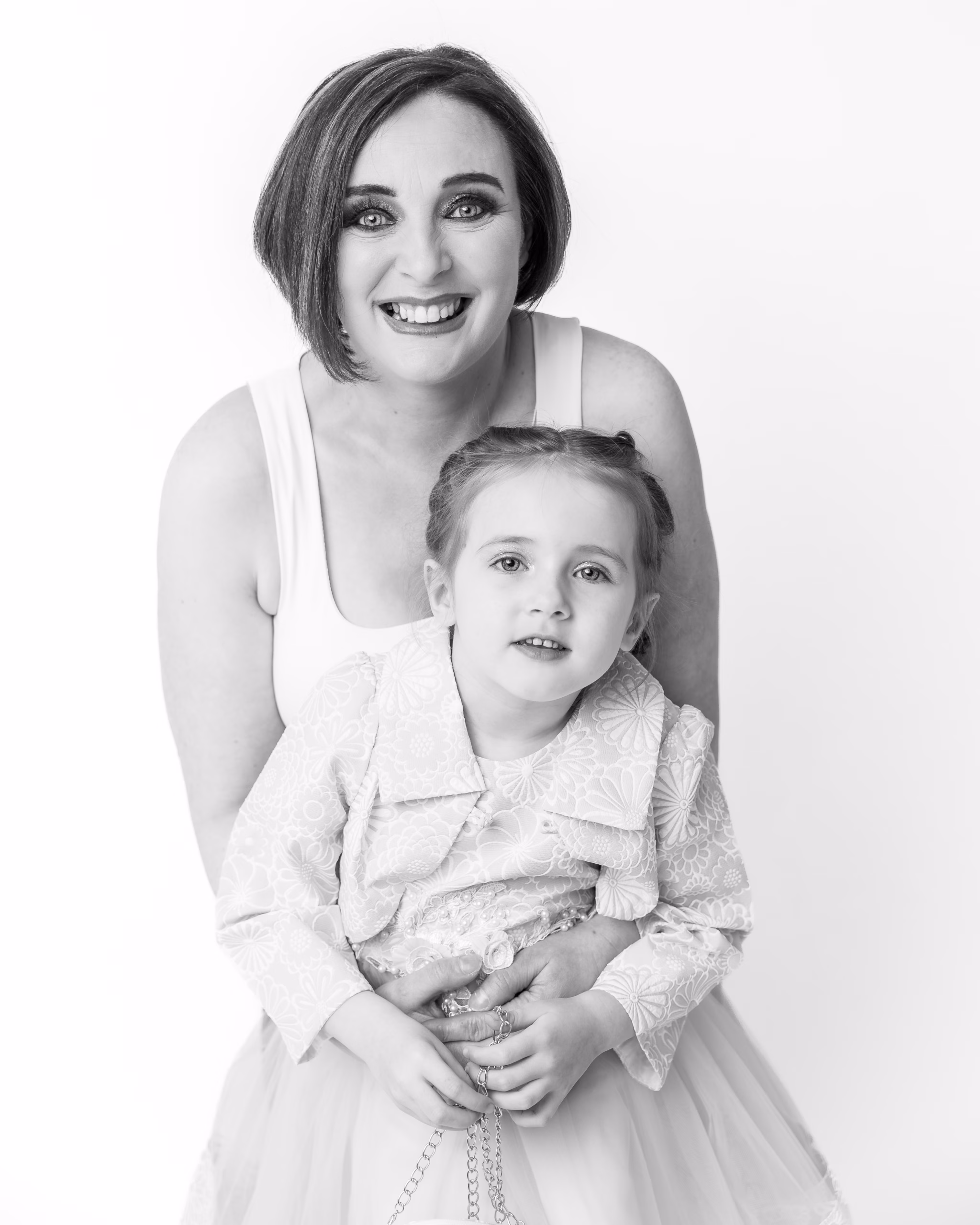 Playful black and white portrait of aunt and niece sharing a moment of connection