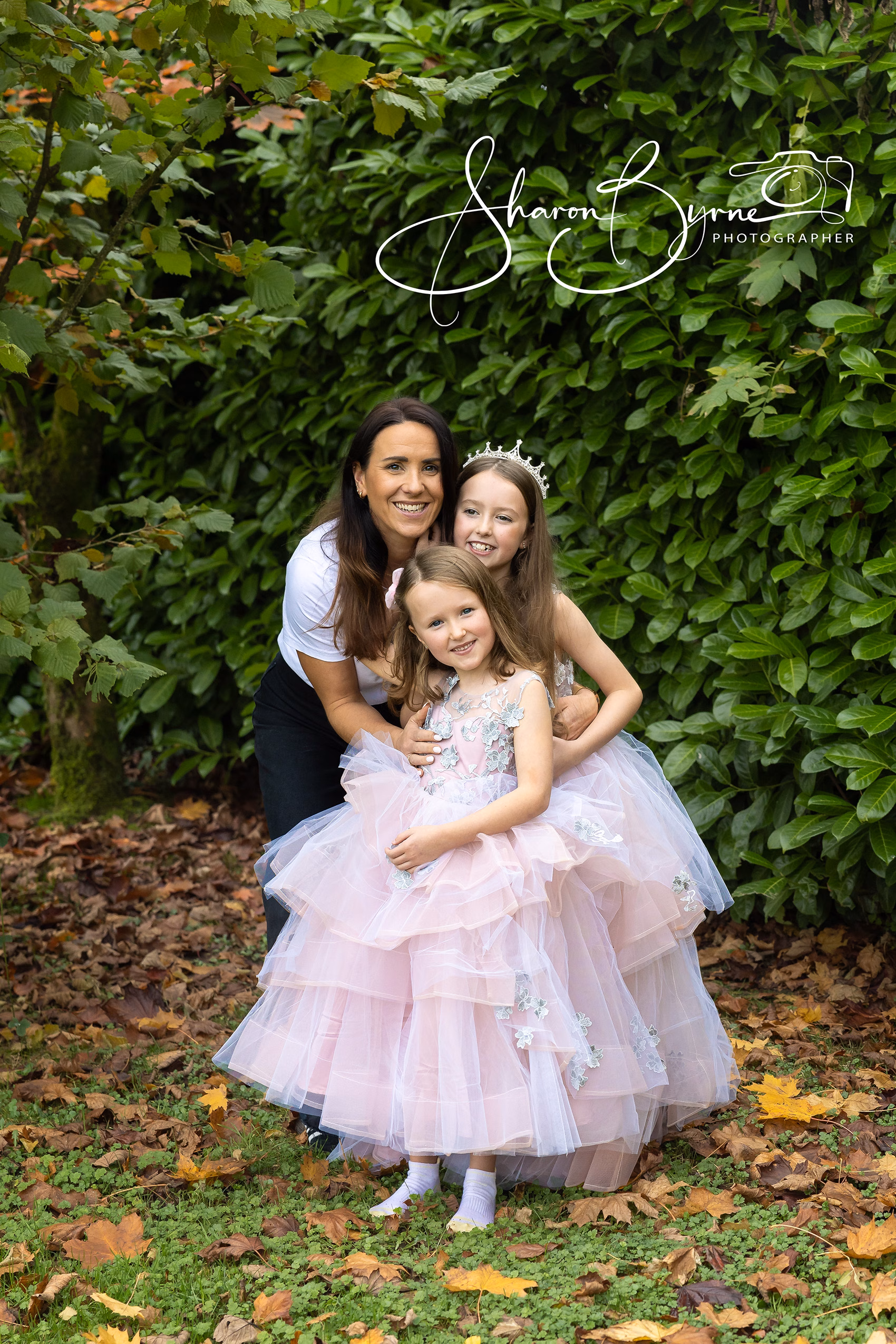 Family portrait photographer - Mother with 2 daughters dressed like princesses, in a beautiful natural pose