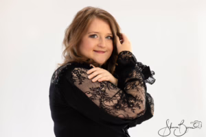Close-up portrait of Aoife smiling in black lace dress during her 30th birthday goth glam photoshoot.