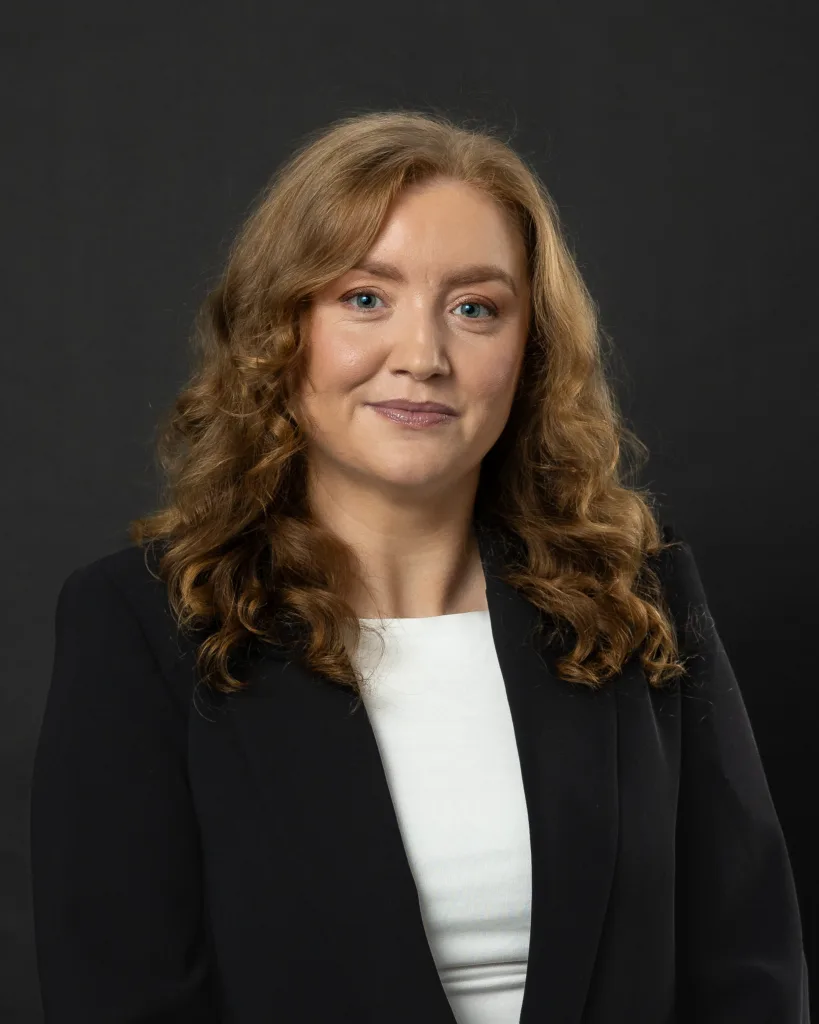 Professional business headshot of a woman in a black blazer, natural expression, taken in a studio near Dublin Ireland
